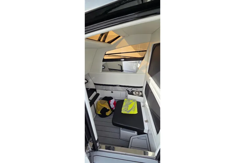 Slide: The Image of Interior of 2026 Nor-Tech 390 Sport Center Console boat, featuring seating and storage. - 11