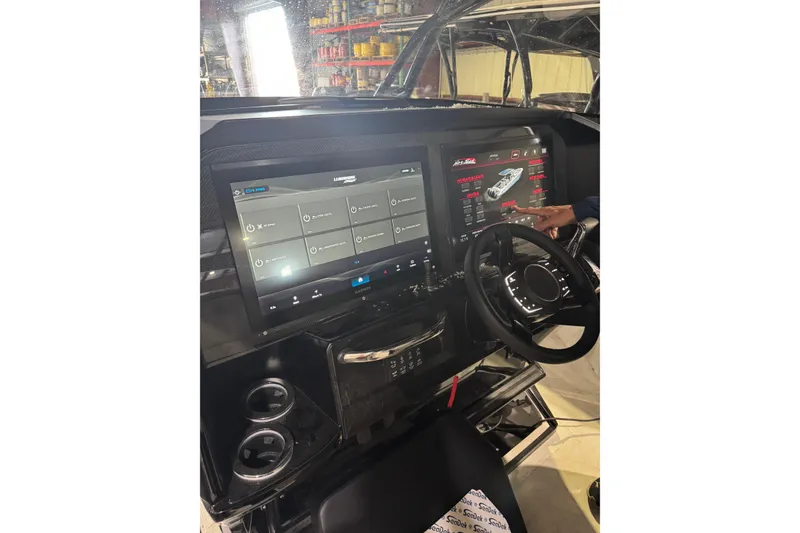 Slide: The Image of 2026 Nor-Tech 390 Sport Center Console dashboard with advanced touchscreen controls and steering wheel. - 4