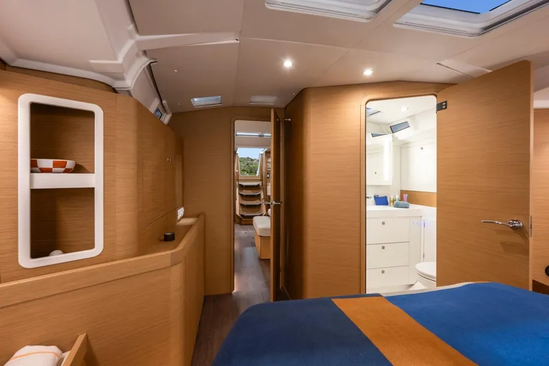 Slide: The Image of Interior of a modern yacht with wood paneling, a bed, and a bathroom. - 7