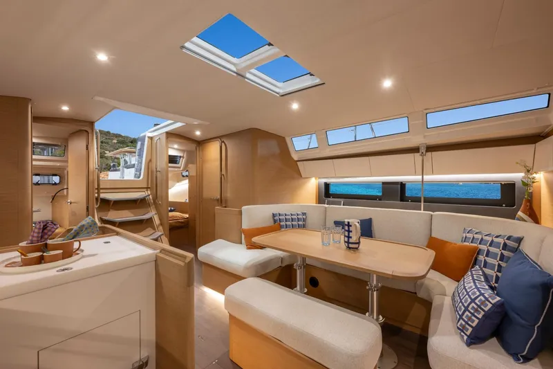 Slide: The Image of Interior of the Jeanneau Sun Odyssey 455 with modern design, light wood, and large windows. - 5