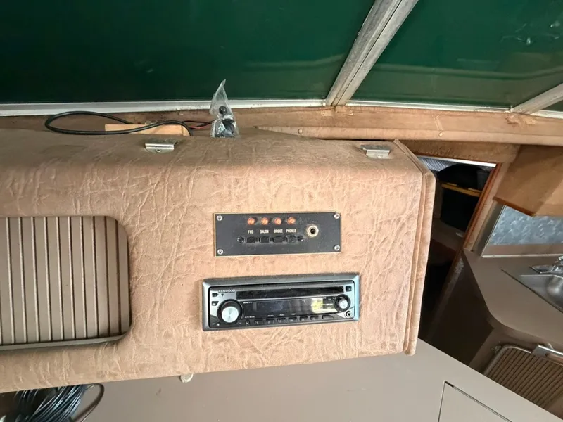 Slide: The Image of Interior view of a 1981 Sea Ray 360 Sportfish featuring a control panel and radio. - 46