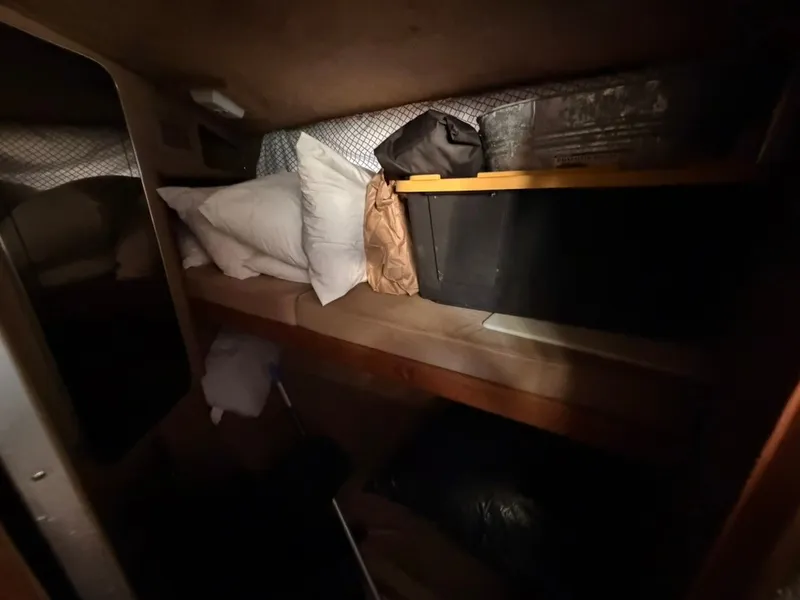 Slide: The Image of A cozy sleeping area with pillows and blankets in a 1981 Sea Ray 360 Sportfish. - 39