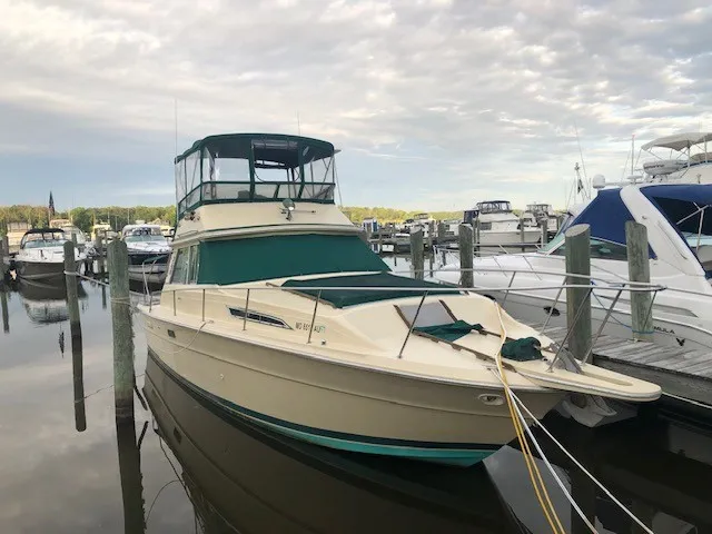 The Image of A 1981 Sea Ray 360 Sportfish docked in calm waters, surrounded by other boats. - 0