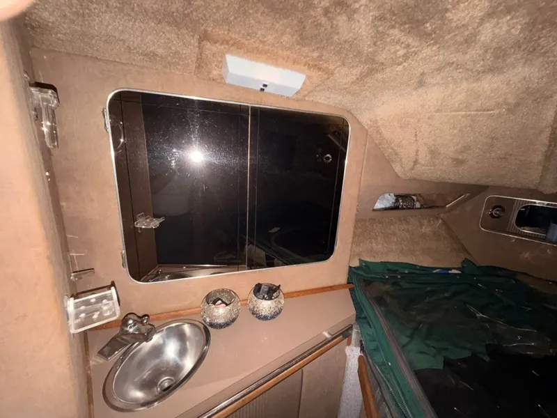 Slide: The Image of Interior of a 1981 Sea Ray 360 Sportfish with a sink and mirror. - 22