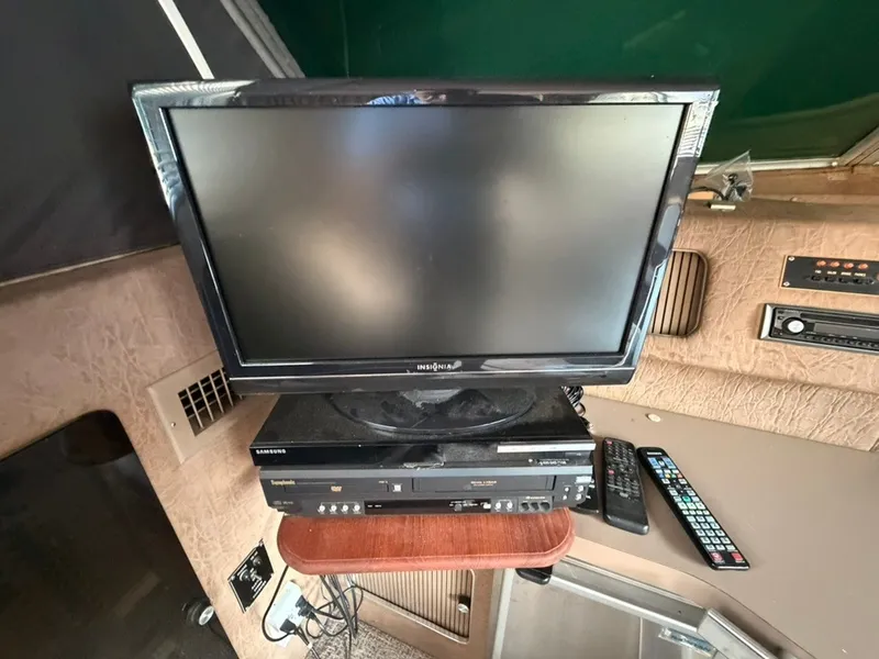 Slide: The Image of A TV and DVD player are installed in a boat, surrounded by wooden walls. - 48