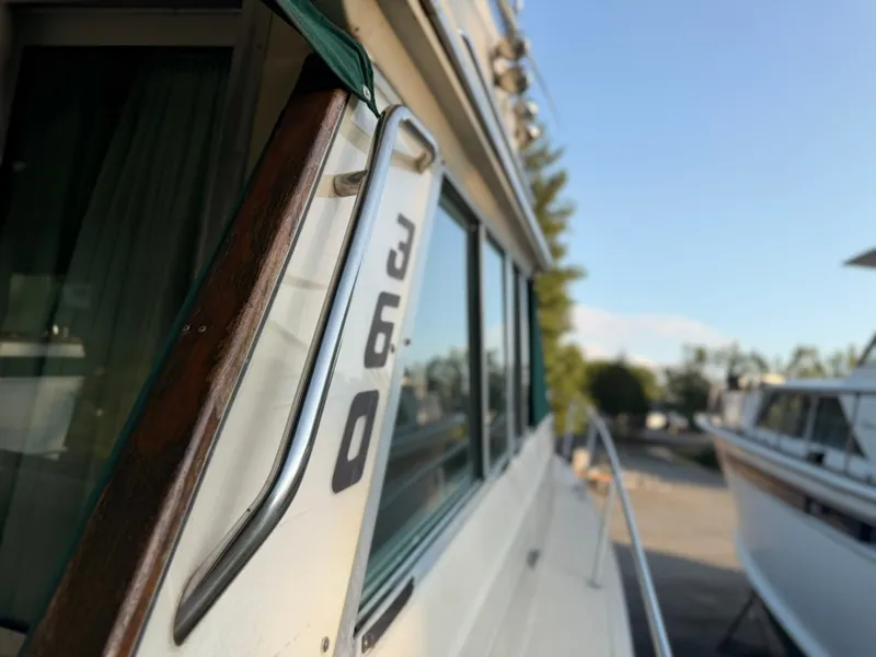 Slide: The Image of Close-up of a 1981 Sea Ray 360 Sportfish with polished metal railing and windows. - 46