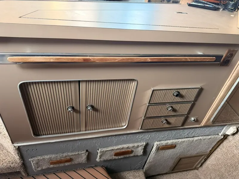 Slide: The Image of Galley area with cabinets and drawers inside a boat. - 27