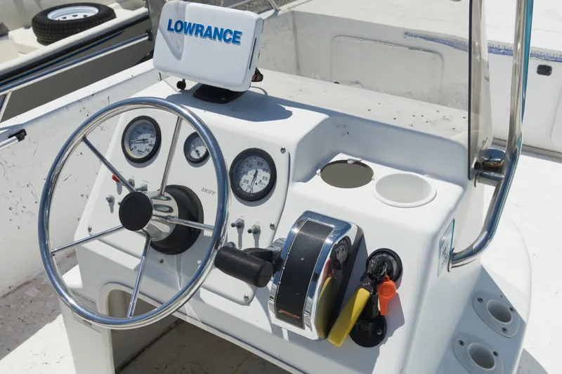 Slide: The Image of Console of a 2006 Seapro 1996 Skiff with steering wheel and Lowrance device. - 12