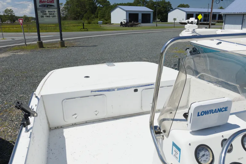 Slide: The Image of 2006 Seapro 1996 Skiff boat with Lowrance equipment, parked near a boat dealership. - 4