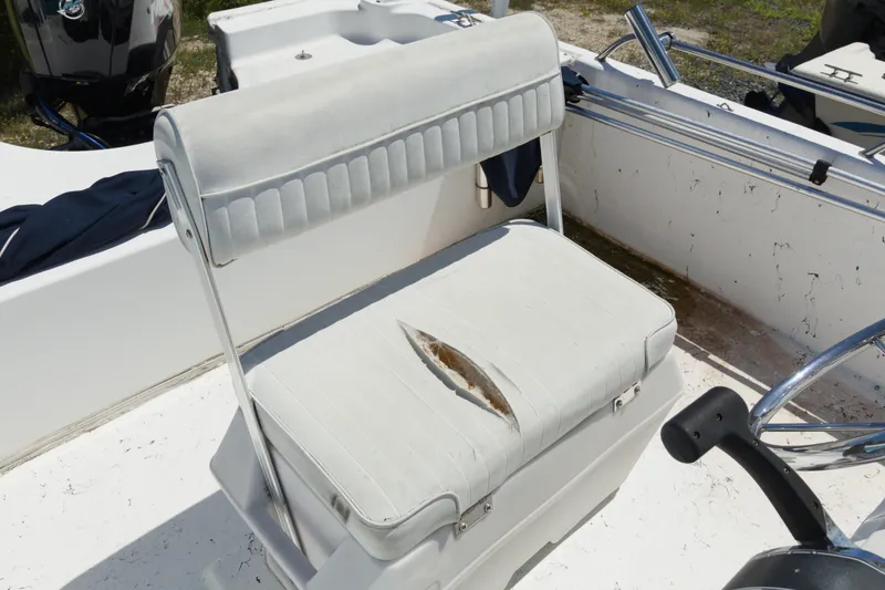 Slide: The Image of Worn seat on a 2006 Seapro 1996 Skiff boat with visible tear. - 11