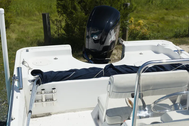 Slide: The Image of 2006 Seapro 1996 Skiff boat with outboard motor, white interior, and seating. - 6