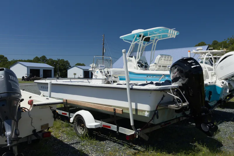 Slide: The Image of Seapro 1996 Skiff boat on trailer, parked outdoors under clear blue sky. - 1