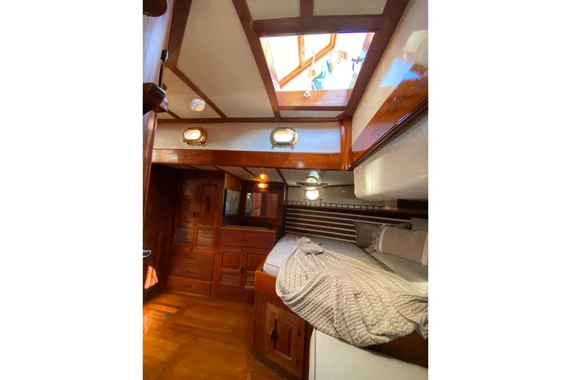 Slide: The Image of Cozy 1976 CT 48 yacht cabin with wooden interior and skylight. - 14