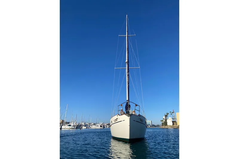 Slide: The Image of 1976 CT 48 sailboat on calm water under clear blue sky. - 31