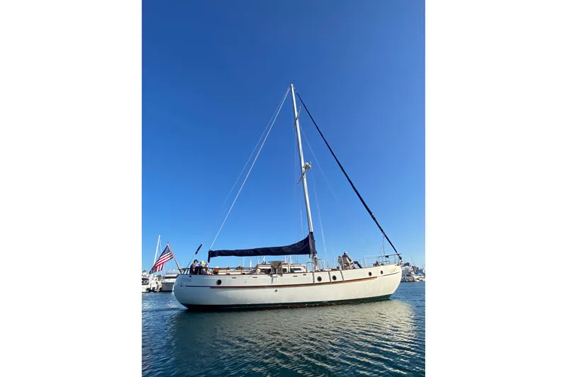 Slide: The Image of 1976 CT 48 sailboat on calm water under clear blue sky. - 32