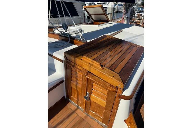 Slide: The Image of 1976 CT 48 sailboat deck with wooden hatch and seating area. - 24