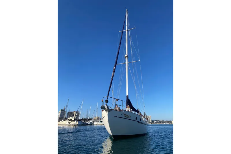 Slide: The Image of 1976 CT 48 sailboat on calm water under clear blue sky. - 30