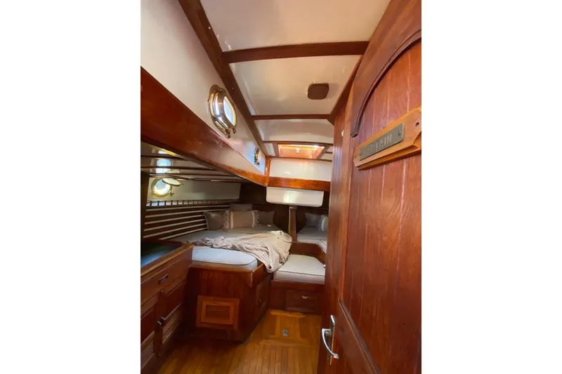 Slide: The Image of Cozy 1976 CT 48 yacht cabin with wooden interior and portholes. - 17