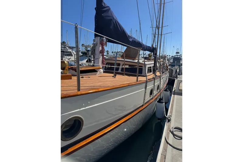 Slide: The Image of 1976 CT 48 sailboat docked at marina, featuring wooden deck and classic design. - 27