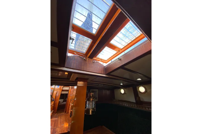 Slide: The Image of Interior view of a boat with wooden fittings and large skylights allowing ample light inside. - 29