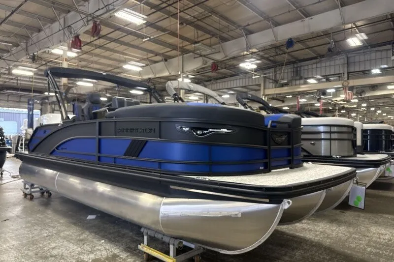 The Image of 2027 Bennington 23 M Swingback pontoon boat in a showroom, featuring sleek design and modern amenities. - 0