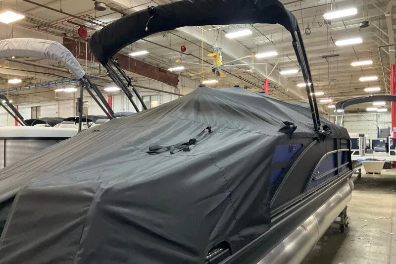 Slide: The Image of 2027 Bennington 23 M Swingback pontoon boat covered in a warehouse setting. - 19