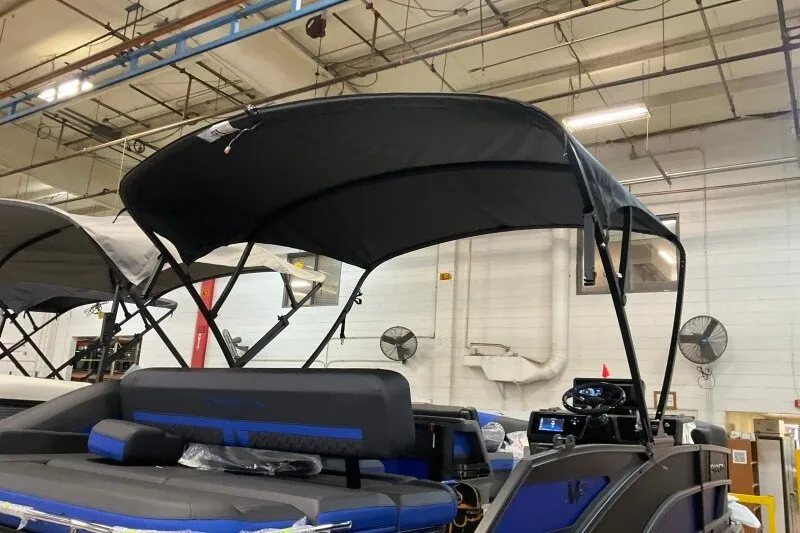 Slide: The Image of 2027 Bennington 23 M Swingback pontoon boat with canopy in a warehouse setting. - 14