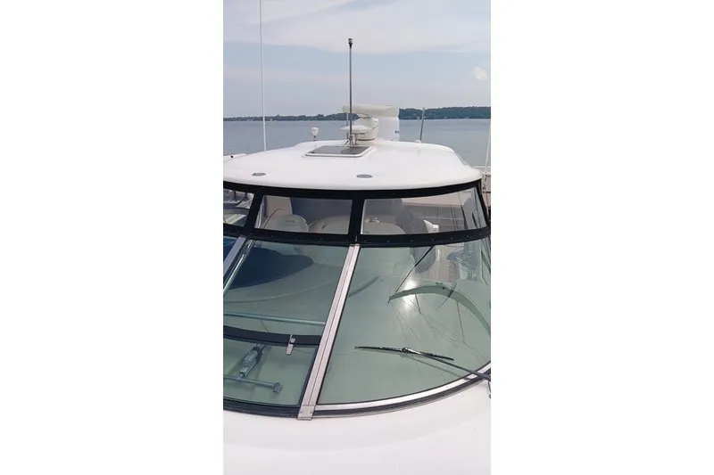 Slide: The Image of 2005 Sea Ray 420 Sundancer yacht with sleek windshield design on calm water. - 4