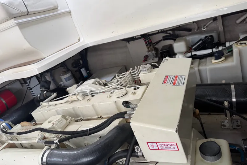 Slide: The Image of Engine compartment of a 2005 Sea Ray 420 Sundancer boat, showcasing mechanical components. - 16