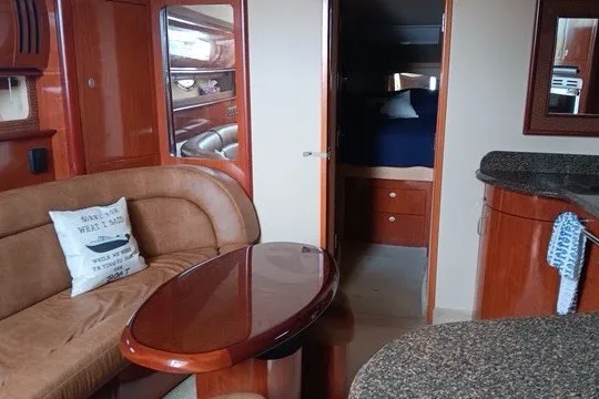 Slide: The Image of Interior of a 2005 Sea Ray 420 Sundancer yacht with elegant wood finishes. - 14