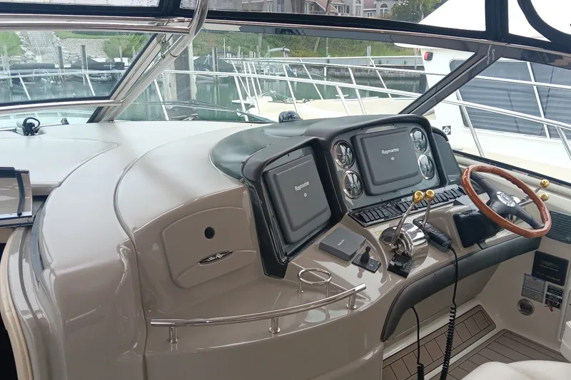 Slide: The Image of Helm of 2005 Sea Ray 420 Sundancer with Raymarine navigation displays and wooden steering wheel. - 8