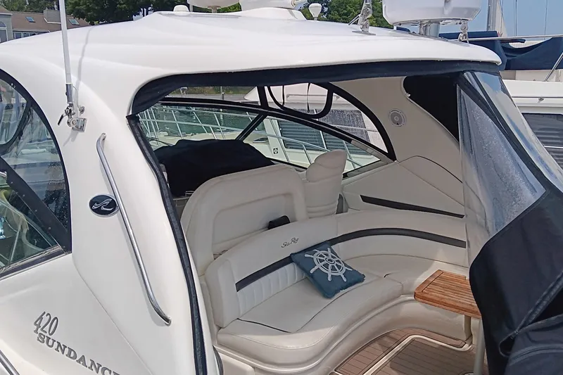 Slide: The Image of 2005 Sea Ray 420 Sundancer yacht interior with white seating and nautical decor. - 2