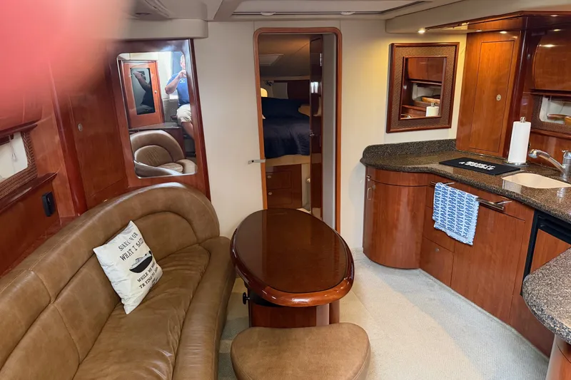 Slide: The Image of Luxurious 2005 Sea Ray 420 Sundancer yacht interior with elegant wood finishes and cozy seating. - 10