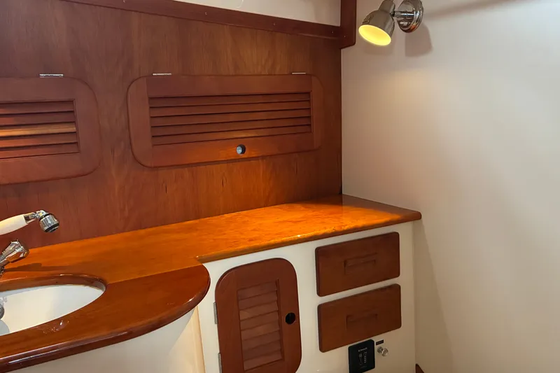 Slide: The Image of 2014 Hinckley Picnic Boat 37 MKIII interior with wooden cabinetry and sink. - 39