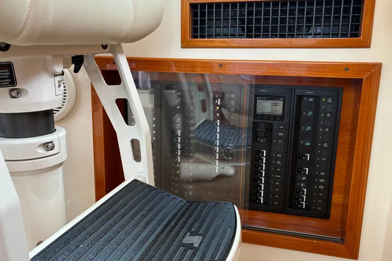 Slide: The Image of Control panel of a 2014 Hinckley Picnic Boat 37 MKIII, featuring modern switches and wood trim. - 24