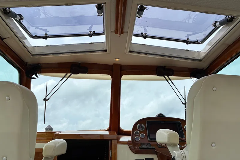 Slide: The Image of Interior view of 2014 Hinckley Picnic Boat 37 MKIII helm with skylights and controls. - 19