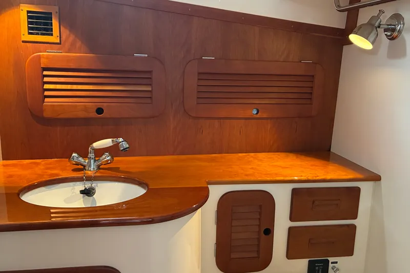 Slide: The Image of Elegant wooden interior of 2014 Hinckley Picnic Boat 37 MKIII with sink and storage. - 36