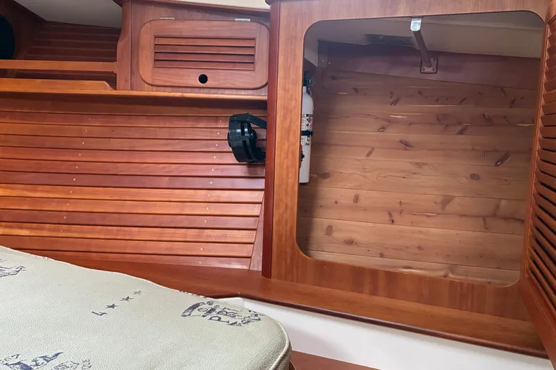 Slide: The Image of Interior of 2014 Hinckley Picnic Boat 37 MKIII with wooden paneling and storage space. - 44