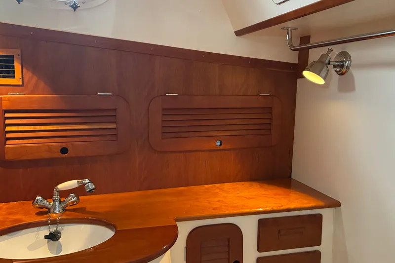 Slide: The Image of Interior of 2014 Hinckley Picnic Boat 37 MKIII with wooden cabinetry and sink. - 38