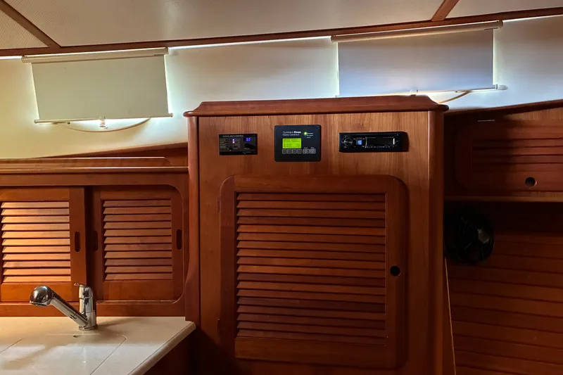 Slide: The Image of Interior of 2014 Hinckley Picnic Boat 37 MKIII with wooden cabinetry and modern controls. - 35