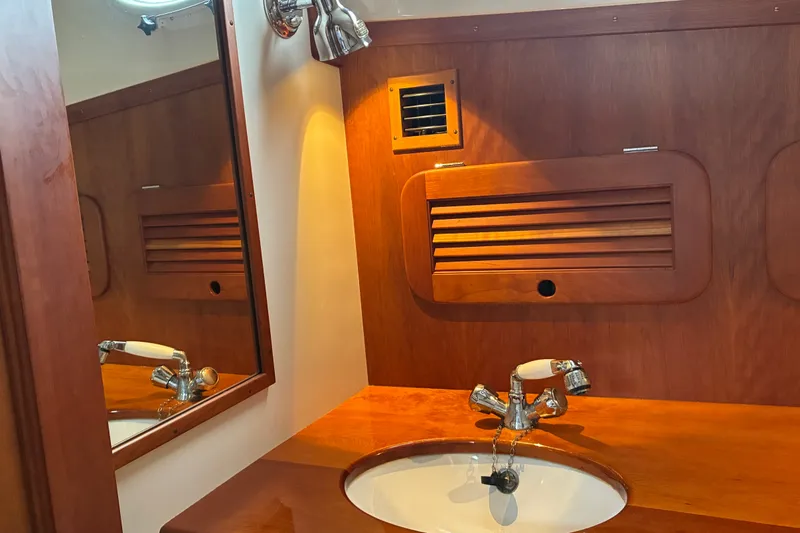 Slide: The Image of Elegant wooden bathroom interior of 2014 Hinckley Picnic Boat 37 MKIII with sink and mirror. - 37