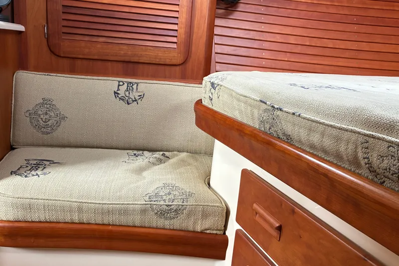 Slide: The Image of Interior of 2014 Hinckley Picnic Boat 37 MKIII with cushioned seating and wooden accents. - 45