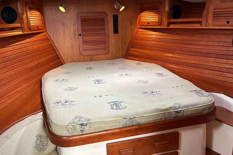 Slide: The Image of Cozy cabin interior of 2014 Hinckley Picnic Boat 37 MKIII with wooden accents and cushioned bed. - 42