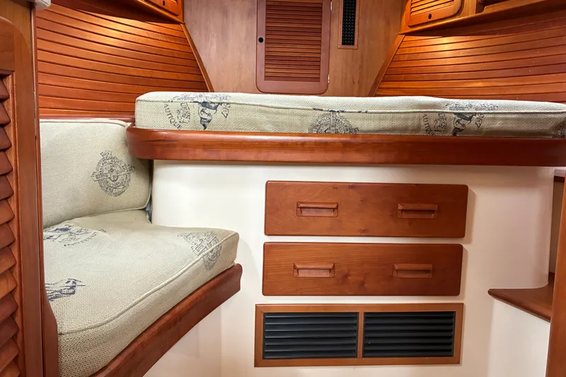 Slide: The Image of Interior of 2014 Hinckley Picnic Boat 37 MKIII with wooden cabinetry and cushioned seating. - 47