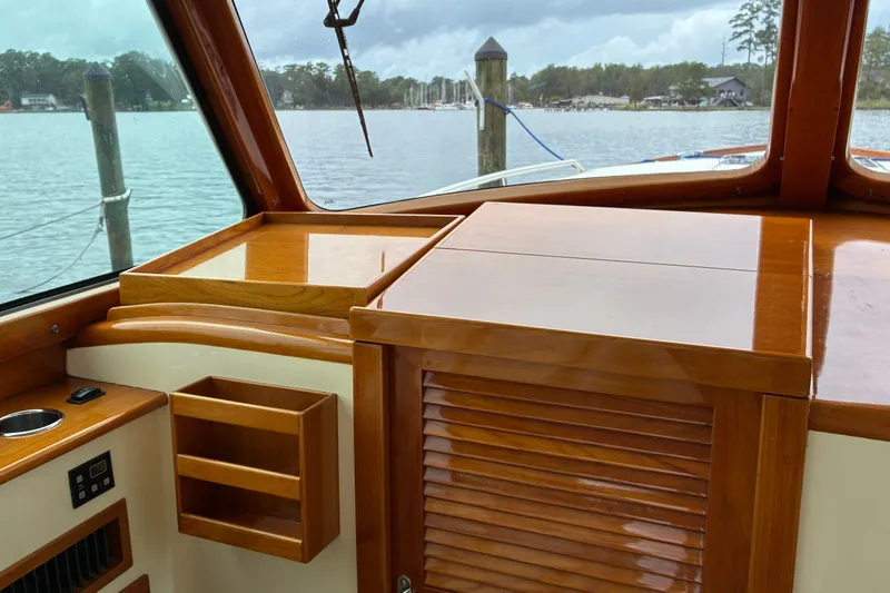 Slide: The Image of Interior of 2014 Hinckley Picnic Boat 37 MKIII with polished wood finish and scenic water view. - 23