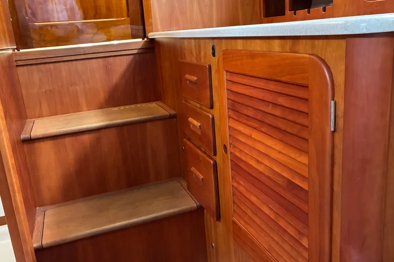 Slide: The Image of Interior of 2014 Hinckley Picnic Boat 37 MKIII with wooden stairs and cabinetry. - 30