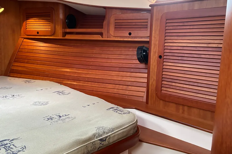 Slide: The Image of Interior cabin of 2014 Hinckley Picnic Boat 37 MKIII with wooden paneling and mattress. - 43