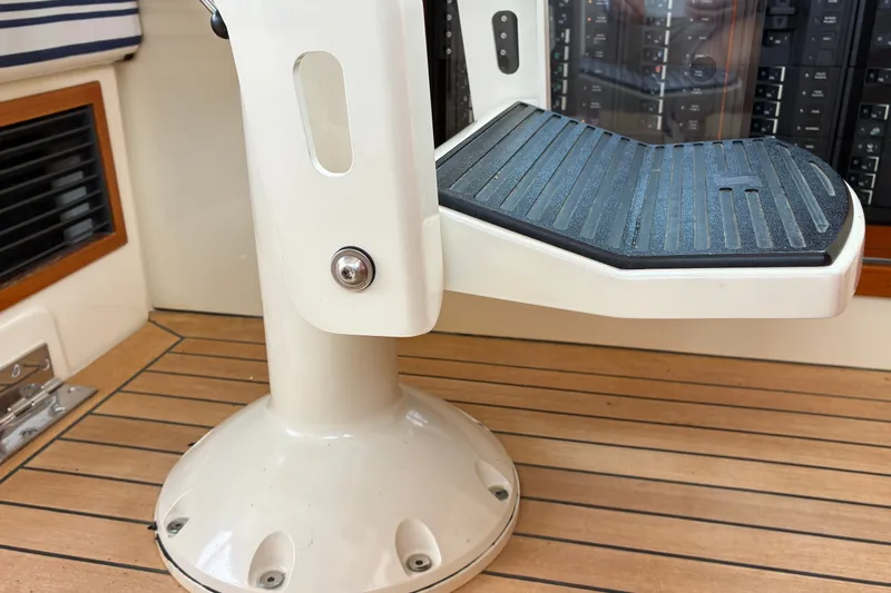 Slide: The Image of Helm seat base on 2014 Hinckley Picnic Boat 37 MKIII with teak flooring and control panel. - 26