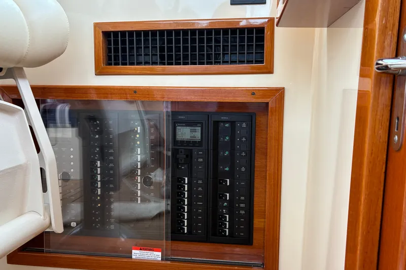Slide: The Image of Electrical panel of a 2014 Hinckley Picnic Boat 37 MKIII with wooden trim. - 25