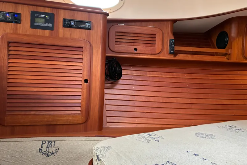 Slide: The Image of Interior of 2014 Hinckley Picnic Boat 37 MKIII with wooden cabinetry and control panels. - 46